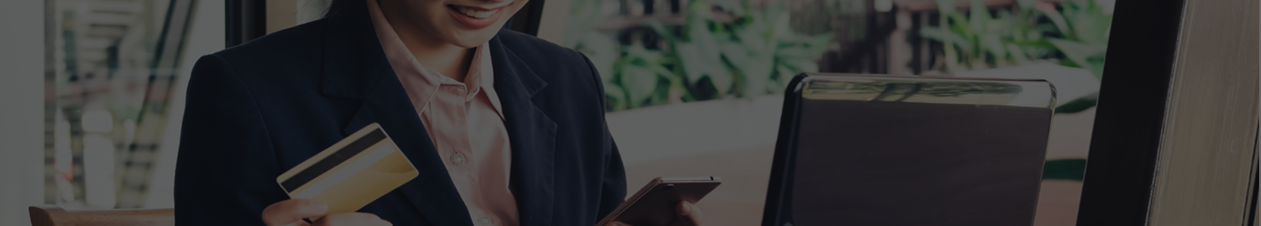 Woman in a suit holding a credit card and smiling banner