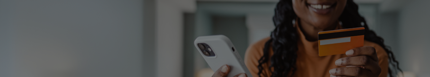 Woman holding her phone and credit card banner